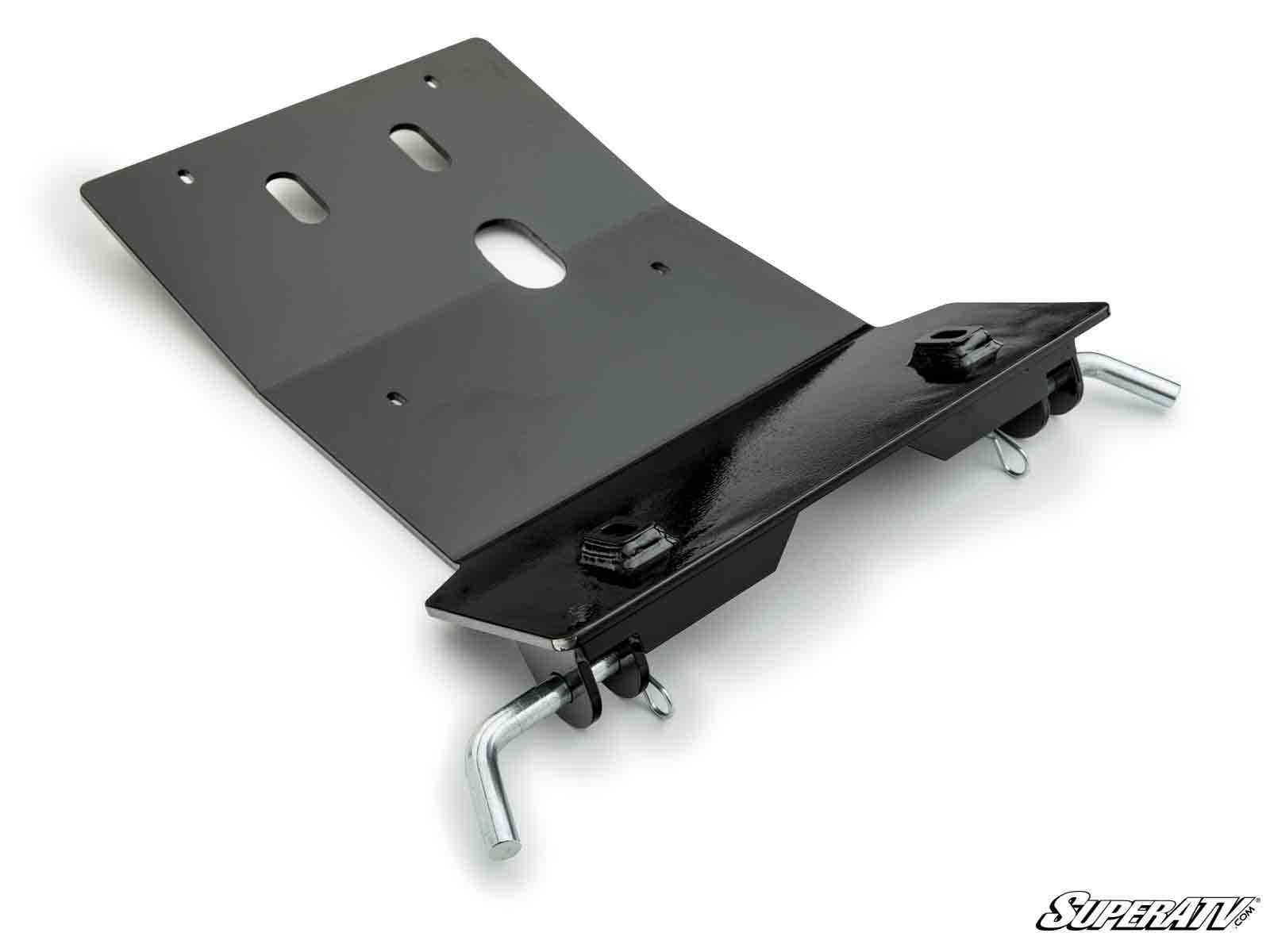 The Yamaha Wolverine X2/X4 850 Plow Pro Snow Plow Mount is a black metal plate with multiple bolt holes and slots, two curved silver mounting pins underneath, large base nuts, and features the SuperATV logo in the lower right corner.
