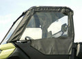 A close-up shows a Canam Defender Upper Soft Door (fits all brand lower doors) with a clear vinyl window panel and visible stitching, covering the side and door. The black enclosure has a slightly shiny finish, with the sky in the background.