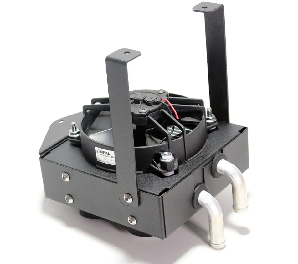 The Inferno Cab Heater Kit With Defrost for 2019-Current Yamaha Yxz includes a black metal heater core with an attached electric fan, two silver inlet/outlet pipes, vertical mounting brackets, visible electrical wires, and bolts securing all components.